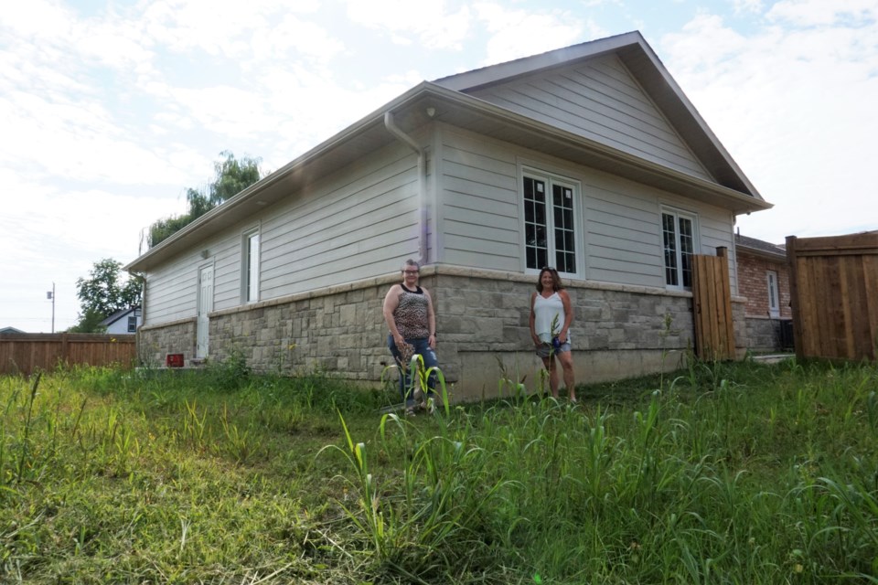 Deb Piggott, fund development manager and Brittany Allcock, program supervisor with Home Horizon, show off the newly built outdoor space at the Barbara Weider House.