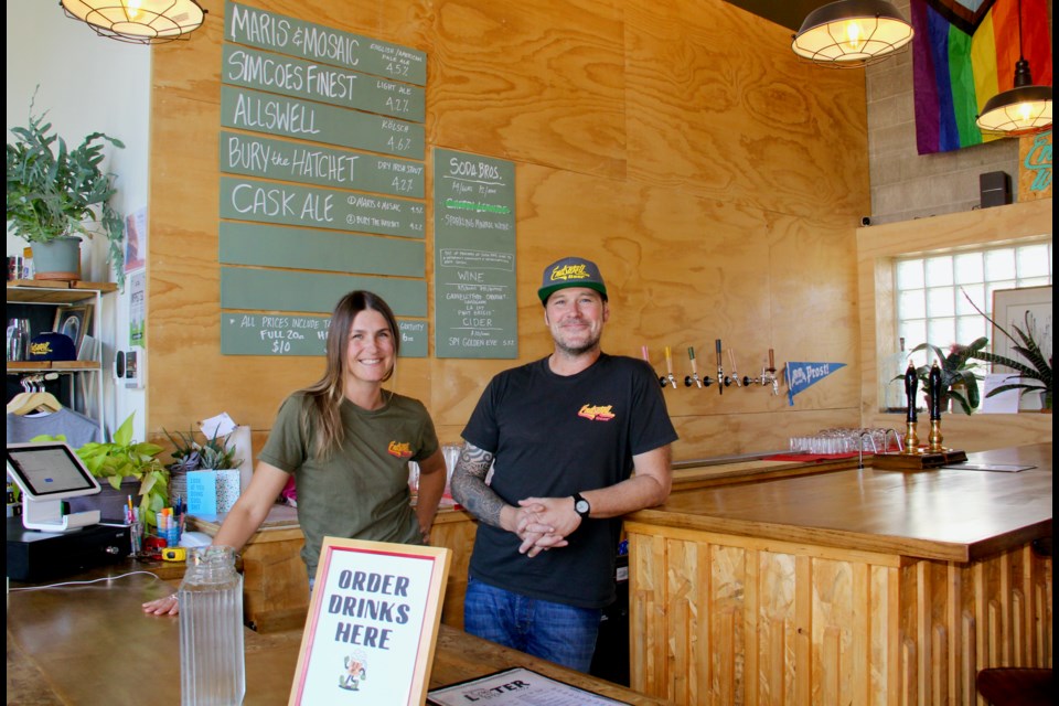 Dana Kaluzny, left, co-owner of Endswell Beer, and Scott Smith are seen in the taproom at Endswell Beer and Later Pizza at 26 Elm St. in Collingwood. 