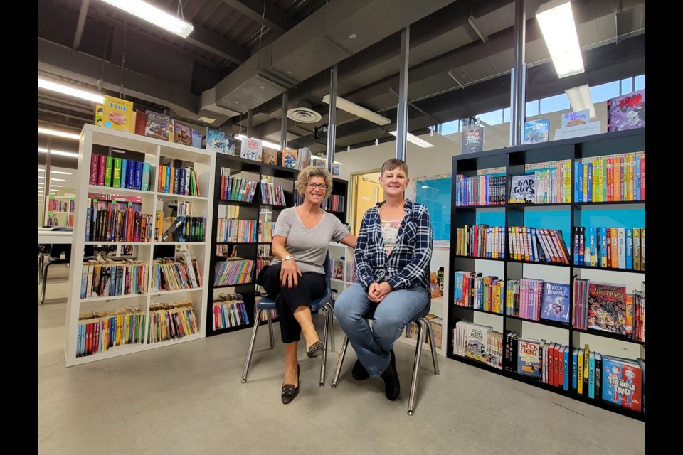 Pretty River Academy's head of school Valerie Turner (left) and kindergarten teacher Judi Scarrow sit in the school's library. Pretty River Academy is celebrating its 25th anniversary this year.