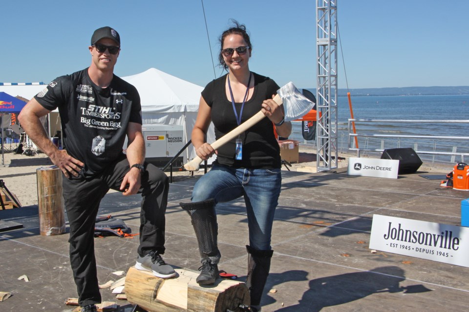 Full disclosure, the notch I cut into the log is on the other side, and it is not that straight. Here's me (Erika Engel) and Stirling Hart on the shore of Wasaga Beach where Hart and others will compete for Canadian Timbersport titles this weekend. Photo by Kelly Elliott of Stihl Timbersports Canada. 