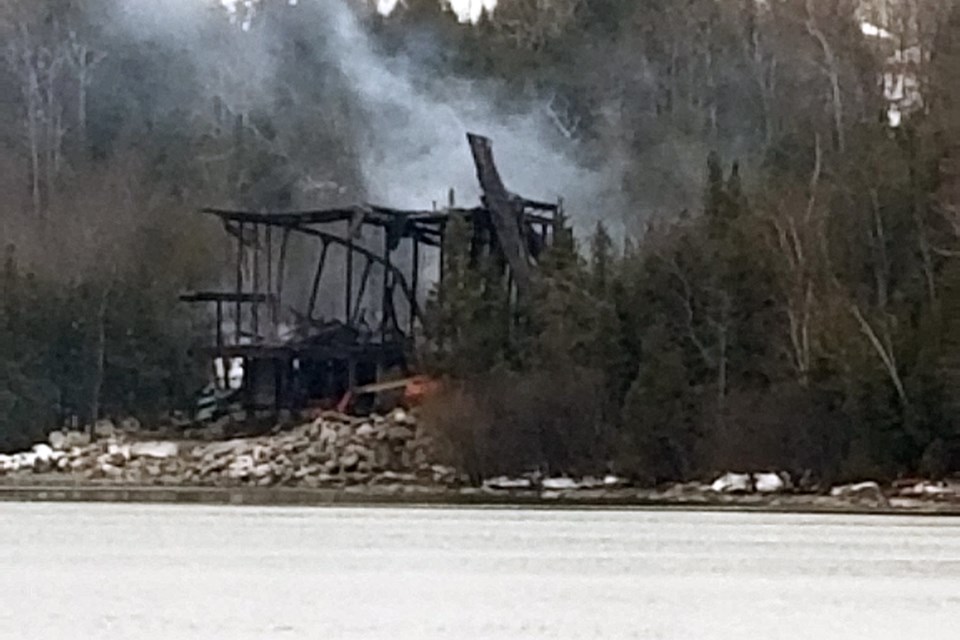 The skeleton of the burned home is now being torn down with machinery. 