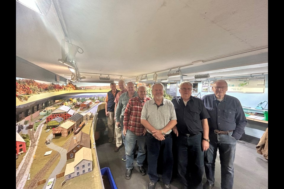 Members of the Nottawasaga Railway Club in the Collingwood section of their 3-D model of the CN Barrie to Meaford line in the 1950s. 