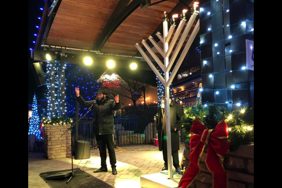 Rabbi Shur leads a menorah lighting ceremony for Chanukah (Hanukkah) on Dec. 10 at Blue Mountain Village. This was the first public menorah lighting for the area.