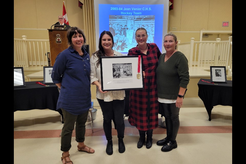 Members of the 2003-2004 Jean Vanier Catholic High School varsity girls' hockey team with coach Liz Peyton, right at the Collingwood Sports Hall of Fame induction ceremony on Oct. 19.