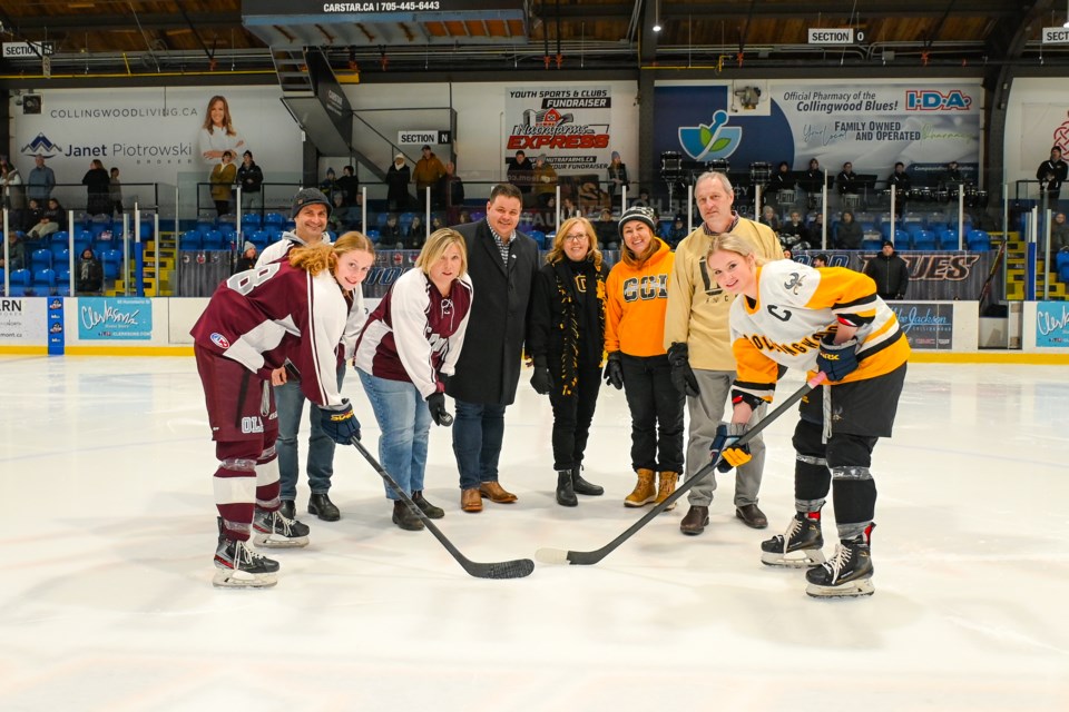 The puck drop for the girls' varsity game. 