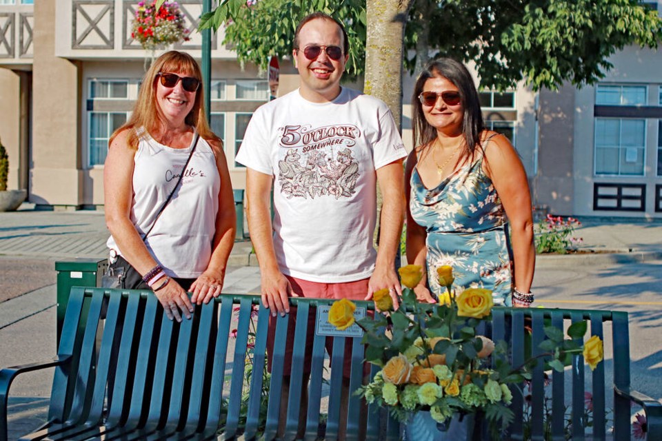 Pictured left to right are; Camille Turner from Camille’s Boutique, Coun. Dylan Kruger and Fashion Fest emcee Meenu Bakshi as they unveil the memorial to Angela Husvik. Jim Kinnear Photo 