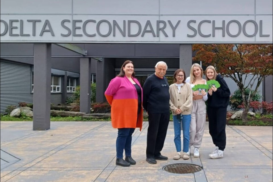 Youth workers at Delta Secondary, who run the Youth Room, Courtney Emison (left) and Venetia Sylvester (3rd left) with Guillermo Bustos, of the Rotary Club of Ladner which sponsors the Food Pantry for students in need, and two students with Save On Foods cards for food purchases from Shred A Thon proceeds. Ladner Rotary Club Photo 