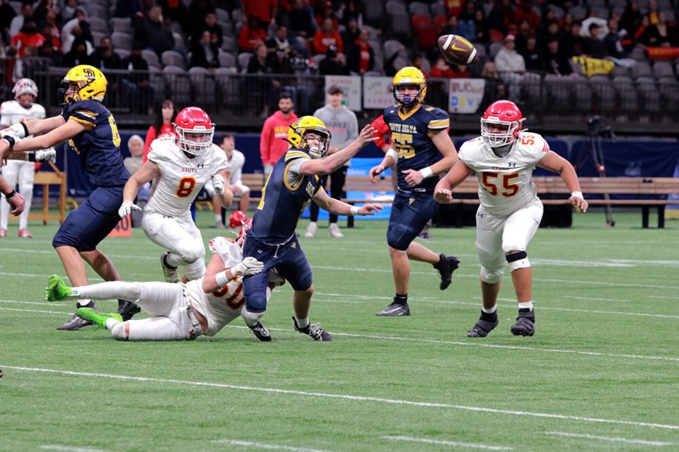 Sun Devils quarterback Damian Dumas flips the ball to a waiting receiver (not pictured) during game action last Saturday (Nov. 23) at BC Place. South Delta beat W.J. Mouat from Abbotsford 43-42 in the BC Highschool AAA semifinal to advance to the championship game this Saturday (Nov. 30) against Vancouver College. Jim Kinnear Photos 