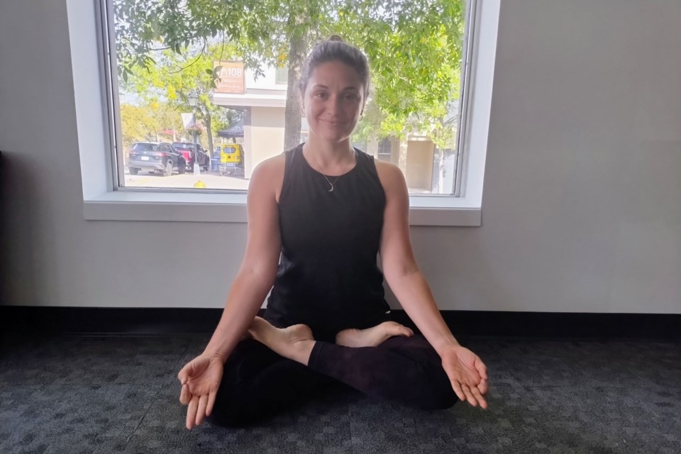 Owner and Yoga Instructor Nadia Carriere demonstrates the 'Lotus' pose