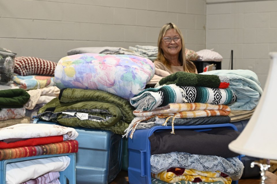 Pastor Alice Forest is shoulders deep in donated linens for the victims of the Hirshhorn apartment complex fire. 