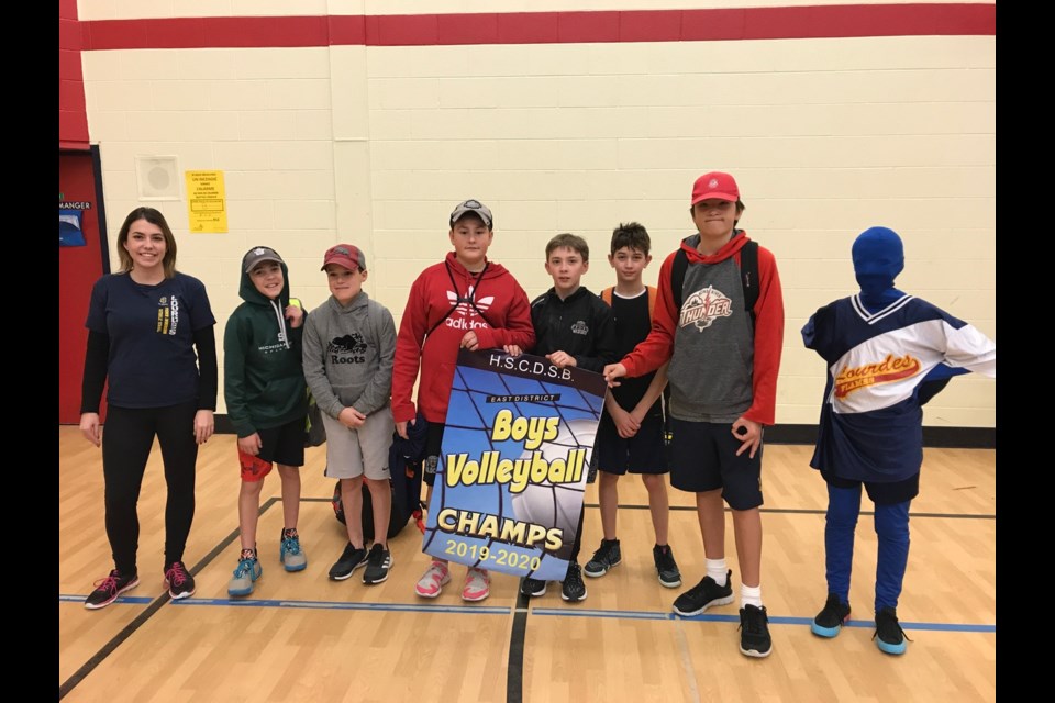 Members of the Lourdes boys volleyball team were (from left) coach Jennifer Smith, Tyler Stefanich, Lukas Schell, Adam Halman, Ayrton Longe, Theo Parsons, Nolan Trudeau. Absent from the picture were  Landon Blair, Jordan Gagnon, Charles Vienneau, Cooper Melis. They were joined by school mascot Bleurde. Photo submitted