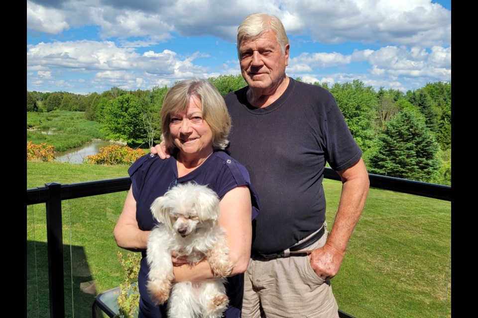 Audrey and Walt Peacock, at home outside Arthur, with one of their rescue dogs. 