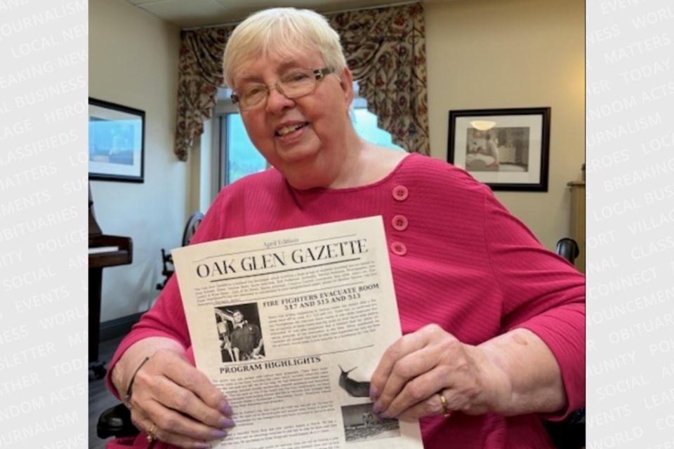 A resident at Wellington Terrace with her copy of the Oak Glen Gazette. 