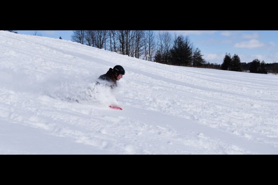 Local residents were out enjoying the fresh snow on a sunny day. Snow started flying when tobogganers picked-up speed at the Wellington County Museum and Archives hill. 