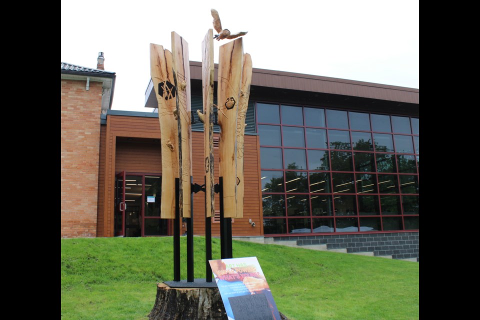 The art piece is made of and mounted on the stump of an old maple tree that fell at the property a few years earlier.