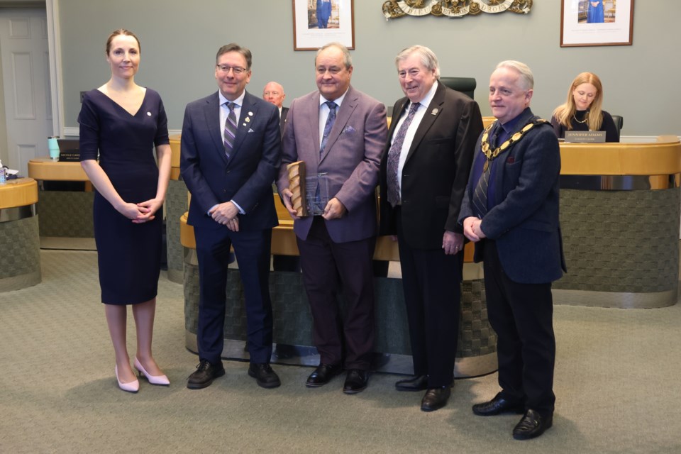 From left, Wellington Place administrator Jana Burns, county councillor and economic development committee chair Jeff Duncan, Wellington-Waterloo Community Futures general manager Rick Whittaker, former county warden George Bridge, and current Warden Chris White pose for a photo as Whittaker accepts a George Bridge Economic Development Award at the Feb. 27 county council meeting.