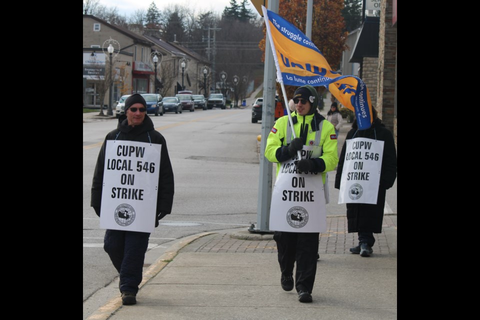 Striking workers march along St. Andrew Street to many honks from passing vehicles and supportive words from pedestrians.