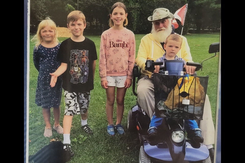 Victor Dockrell uses his mobility scooter to do a paper route with his grandchildren. 