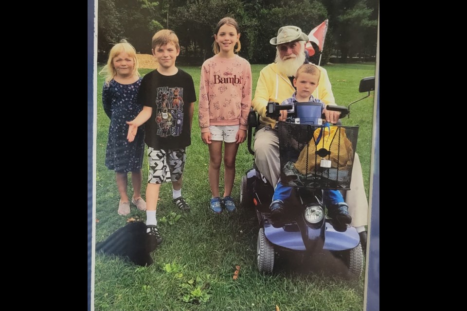 Victor Dockrell uses his mobility scooter to do a paper route with his grandchildren. 