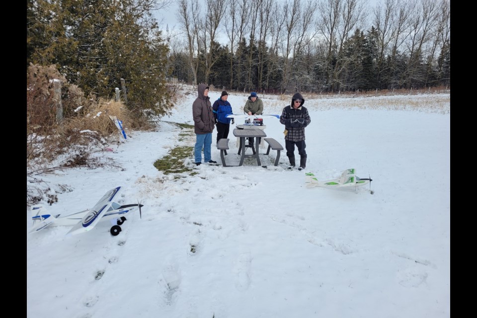 Chief Flight Instructor Tom Lundhild (right) tests his electric Timber on skis prior to flight.