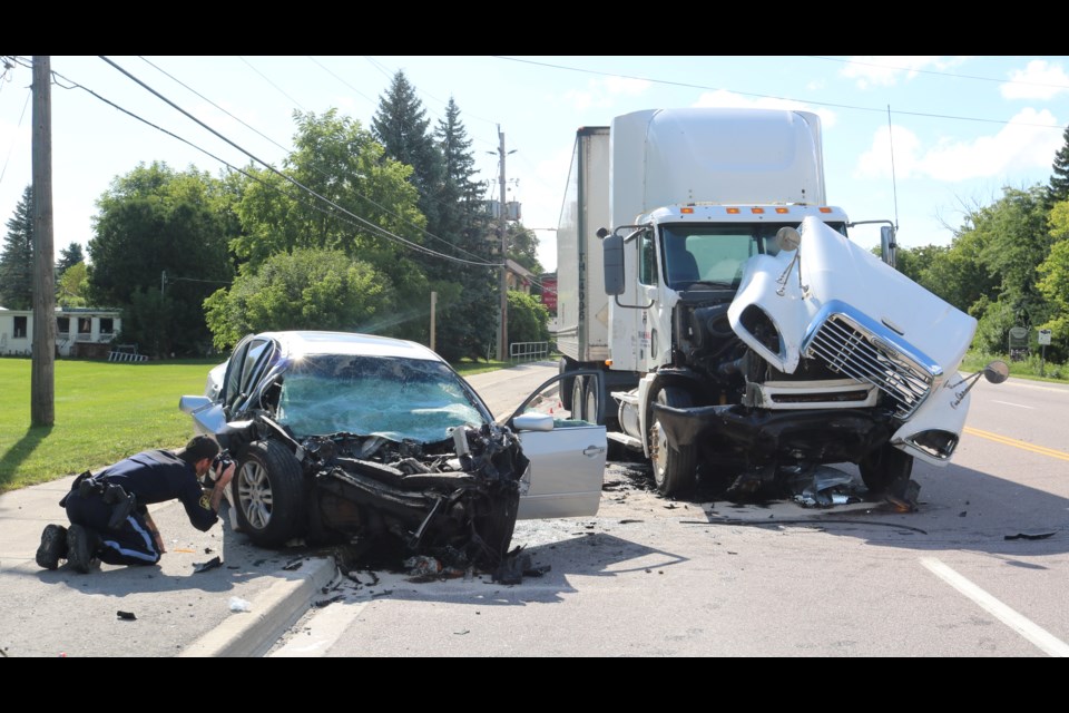 A transport truck and silver car were involved in the collision. 