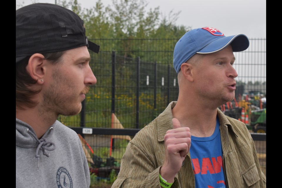 Coworkers, friends and Jasper evacuees Austin Huchison and Adam Hvisc speak outside the Edmonton evacuation centre, where as of Thursday 439 people had sought support. /Craig Gilbert photo