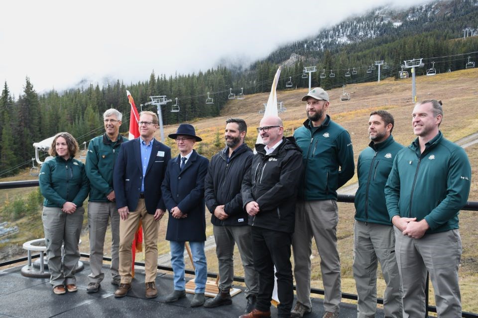 Federal Employment Minister Randy Boissonnault, fourth from the right, Jasper Mayor Richard Ireland, fourth from the left, Parks Canada staff and others at Marmot Basin in Jasper National Park during a federal rent relief announcement on Thursday (Oct. 10).