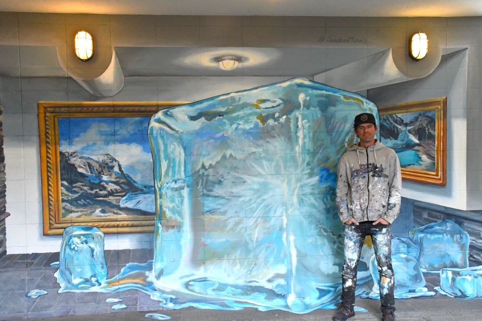 Tyler Toews spent last week completing this glacial awareness mural at the top of the stairs to Sunhouse Café and Rockaboo Mountain Adventures at 610 Patricia Street. This was the first mural for UpLift! 2024. | Peter Shokeir / Jasper Fitzhugh