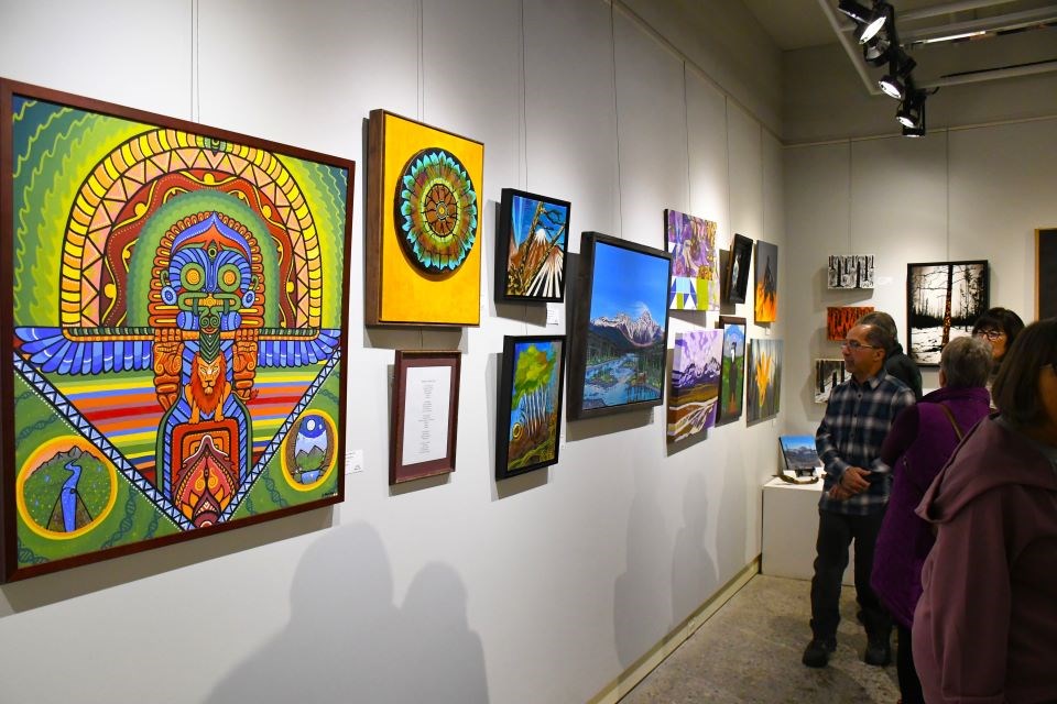 Guests look at wildfire-inspired art during the opening gala of the BUZZ 2025 Exhibit at the Jasper Art Gallery on Friday, Jan. 17, 2025.