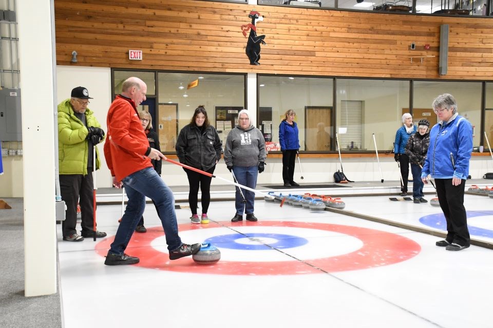 Retired curler Kevin Martin gives tips during a stick curling session at the Jasper Curling Rink in Jasper, Alta. on Friday, Jan. 24, 2025.