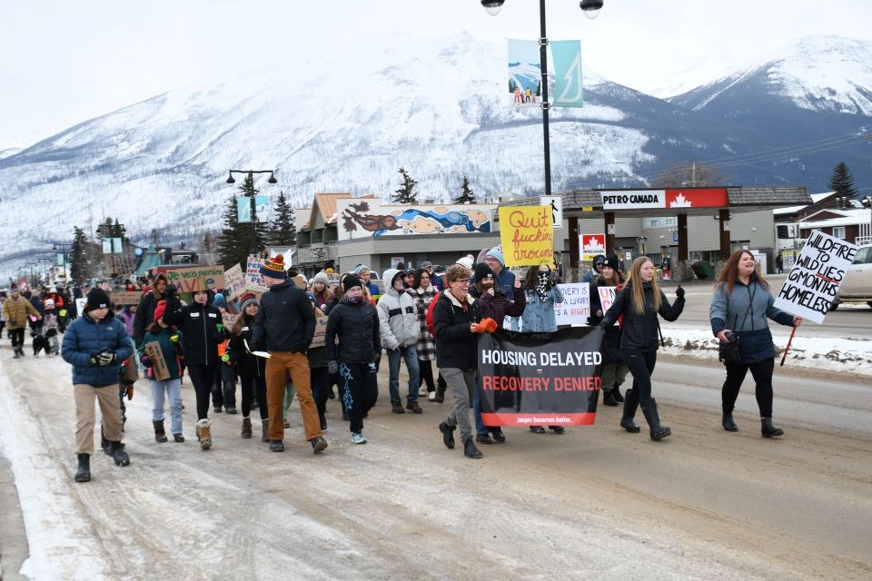 Protesters calling for interim housing march down Connaught Drive in Jasper, Alta. on Friday, Jan. 24, 2025.