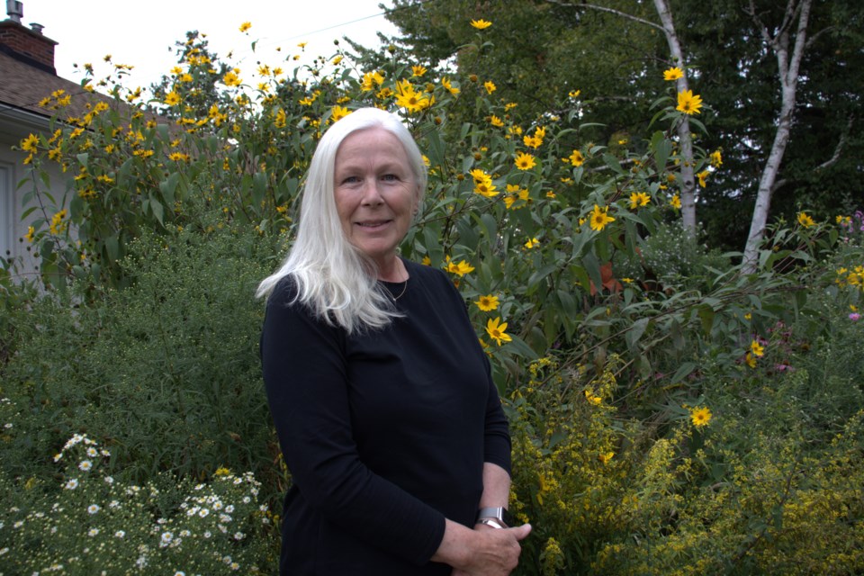 Ann Martin with her rain garden, made up of native Ontario plants. She is a 2024 recipient of the Halton Watershed Stewardship Award. 