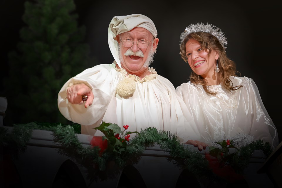 Ebenezer Scrooge (Erik Peters) is visited by the ghost of Christmas Past (Anastasia Saluk) in the Village Theatre production of A Christmas Carol,  which opens Nov. 22.