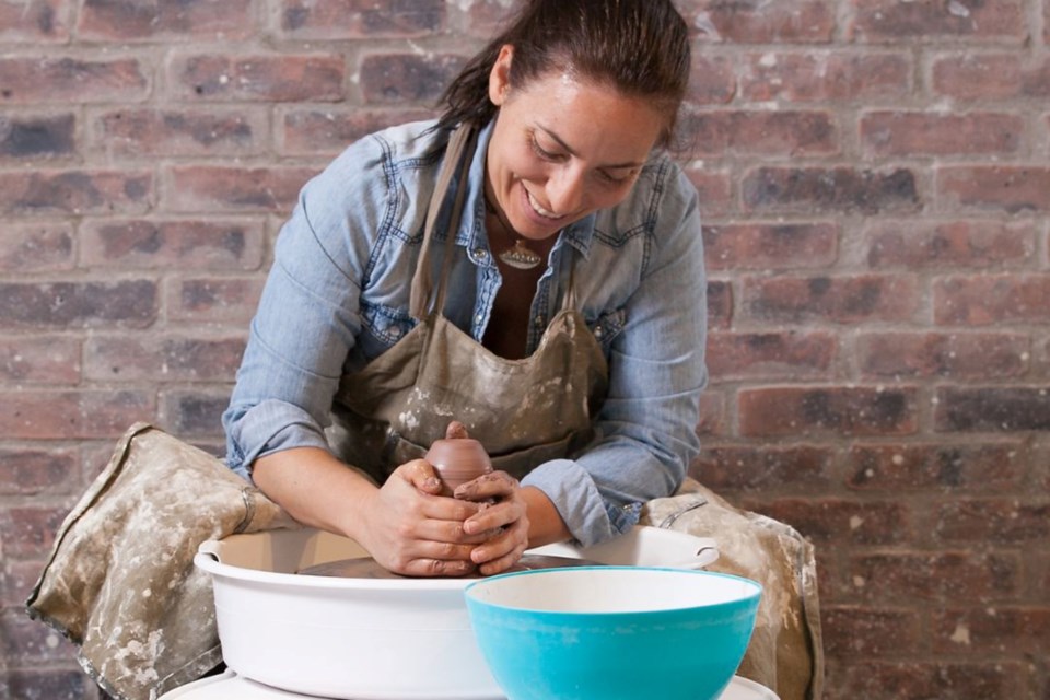 The author tries her hand at the wheel at Creative Insight Pottery & More.