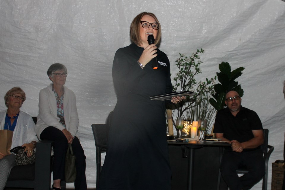 Eagles Nest executive director Amanda DeVries speaks during the fundraiser at Shy's Place Tuesday evening. 