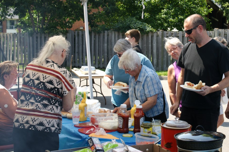 2024-07-28-legion-corn-roast-attendees-loading-their-plates-gf