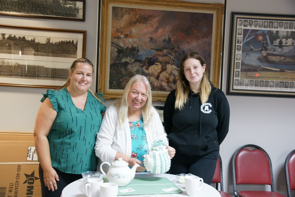 Tammy Taylor (centre), daughter Krystal Phau (left) and step-grand-daughter Avery Phau get ready to pour at the Waterdown Legion's community tea party Sunday.