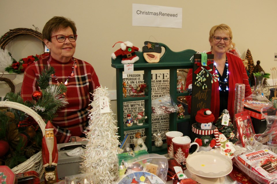 Brenda St. Amant and Lachlan Mcleod look after the Christmas Renewed table at the Grace Anglican Church Christmas Market on Saturday.