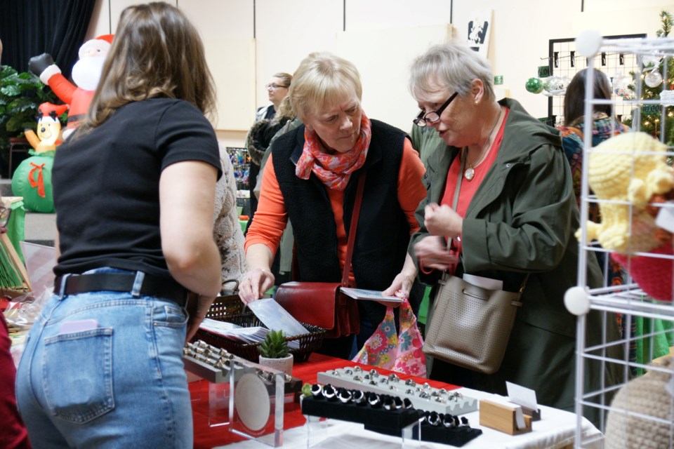 Joanne Ferrier and Nelly Simmelink of Stoney Creek check out rings at Kate Hughes's stall at the Waterdown Legion Christmas Craft Show on Saturday.