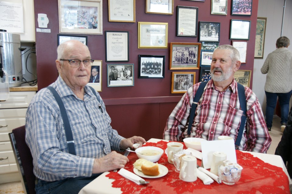 Larry Swaney and Harry Vandergiessen enjoy their soup and chili - and a good visit - at the Westover WI community lunch on Saturday.