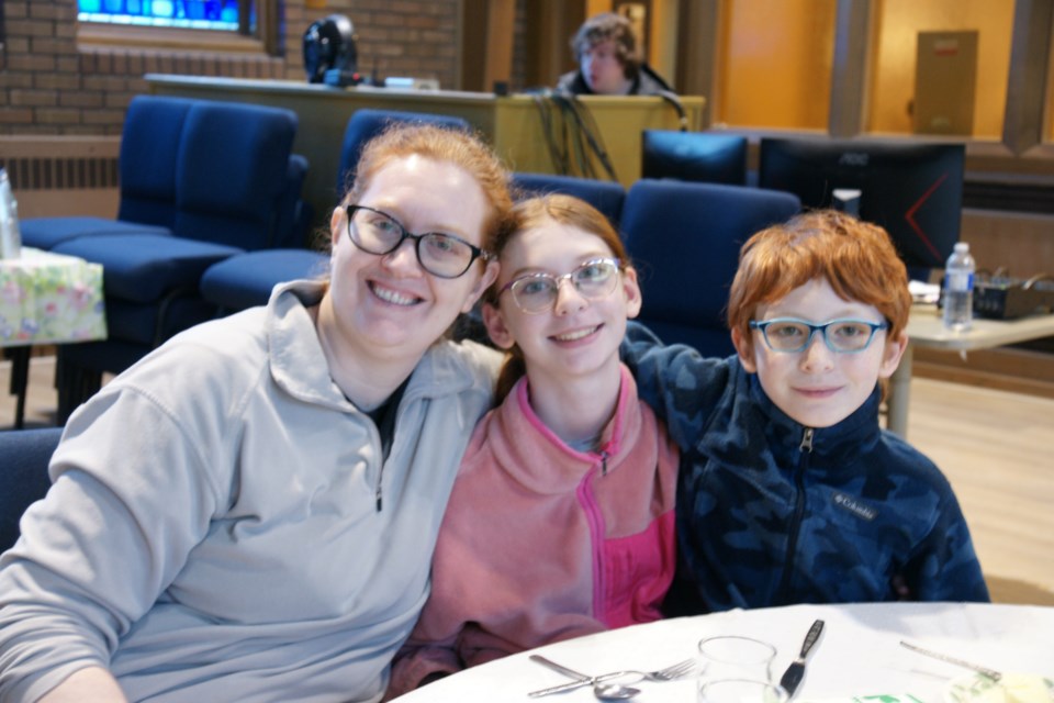 Amanda Woodworth, daughter Anne and son Alem have some fun at the St. James Irish Supper.