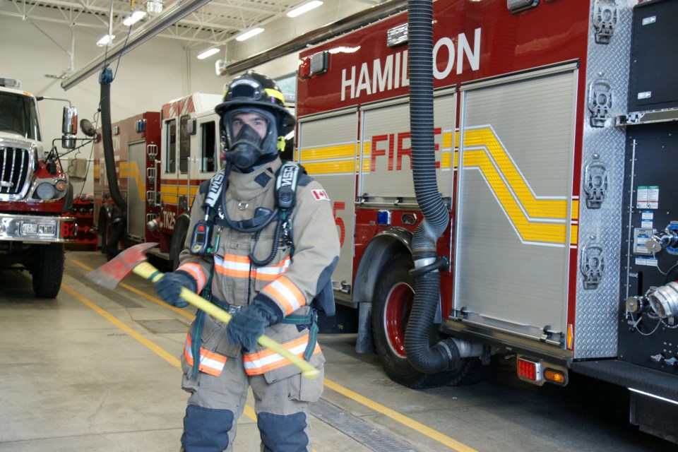 Greensville firefighter Adam Lennox is decked out in about 40 pounds of gear at the Thanksgiving Day open house at the Old Brock Road station. 