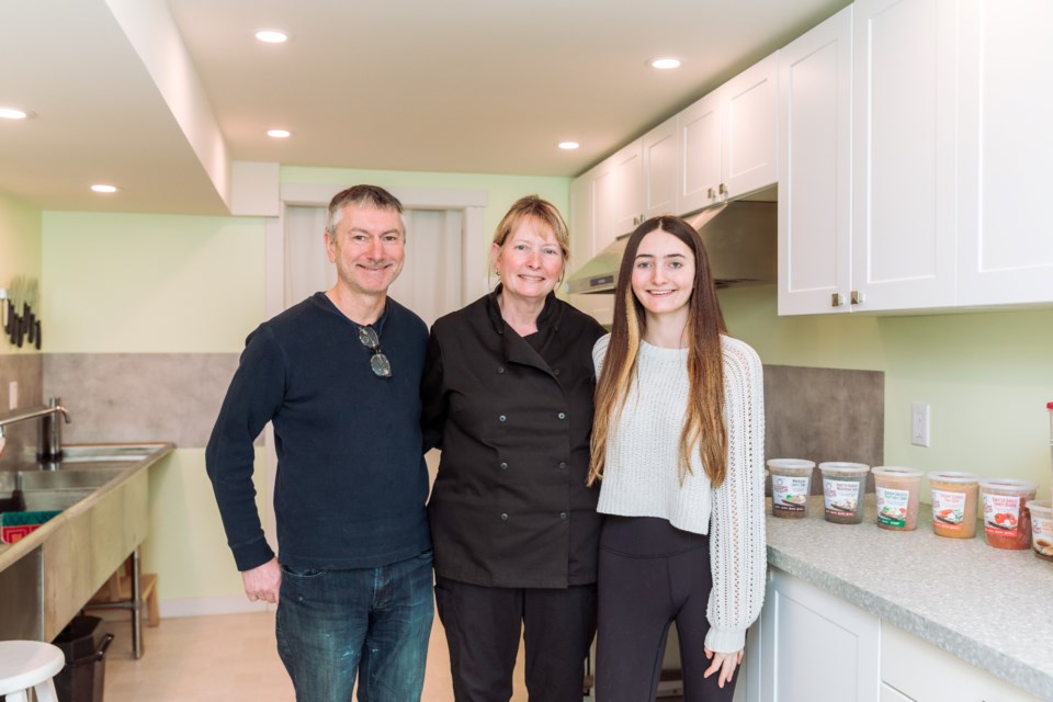 Chef Liz Pietrzak (centre) in the kitchen with husband Richard and daughter Stephanie.