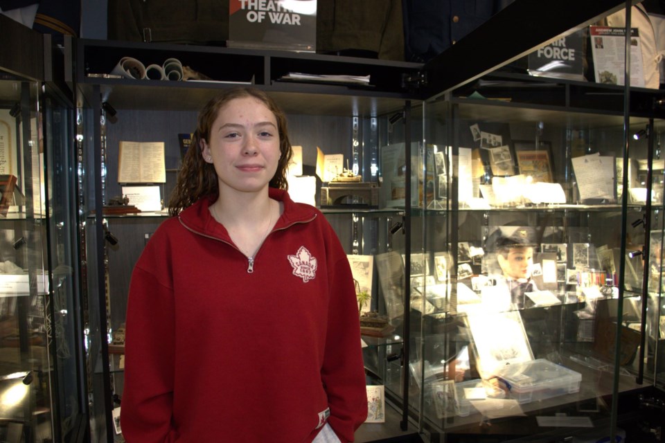 Grade 11 WDHS student Tamara Robichaud stands in front of the cases at the Museum of Hope. Robichaud is working on an exhibit about her great-grandfather who fought for six years in the Second World War. 