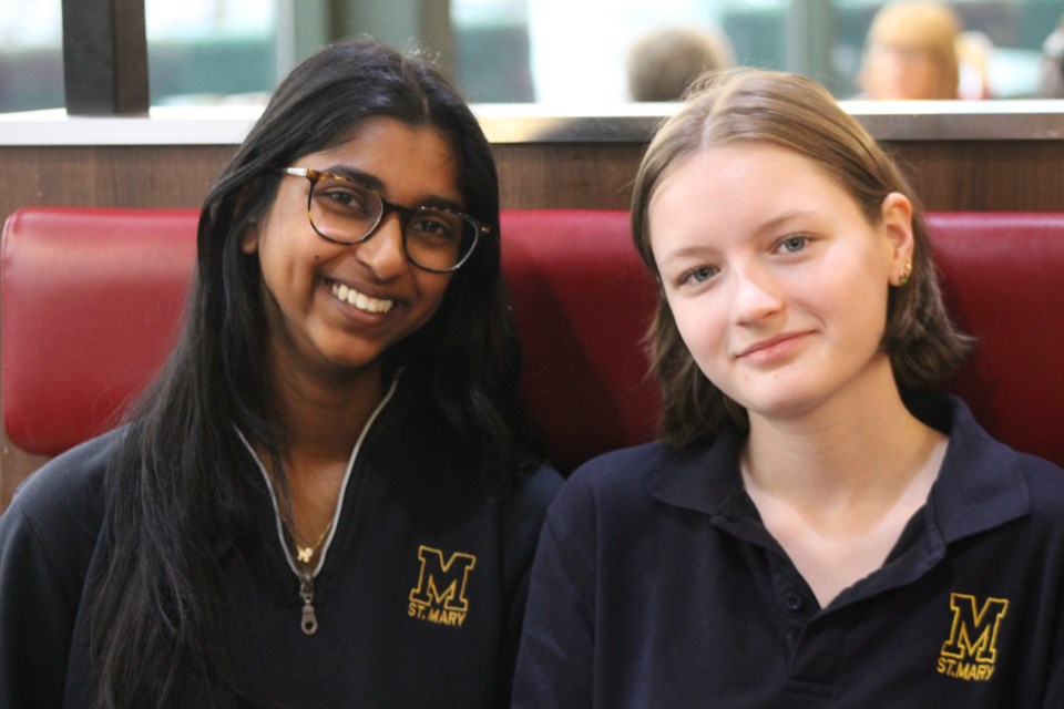 St. Mary Catholic Secondary School students Maya Rajan (left) and Abby Katherine combined their passion for literacy with a DECA project to organize their Pocket Library book drive.