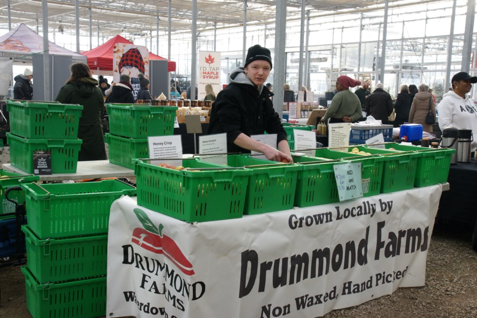 Evan looks after the Drummond Farms stand at Connon's Winter Market on Saturday.