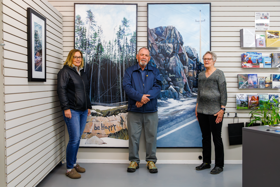 Creighton Community School principal Patty Korchinski, Flin Flon Mayor George Fontaine and NorVA Centre and Gallery board member Jan Modler present a pair of paintings by local artist Catherine Joa at the centre last week. After a fundraising blitz, the two pieces, showing rock graffiti with positive messages, will be heading to the school and to Flin Flon City Hall.