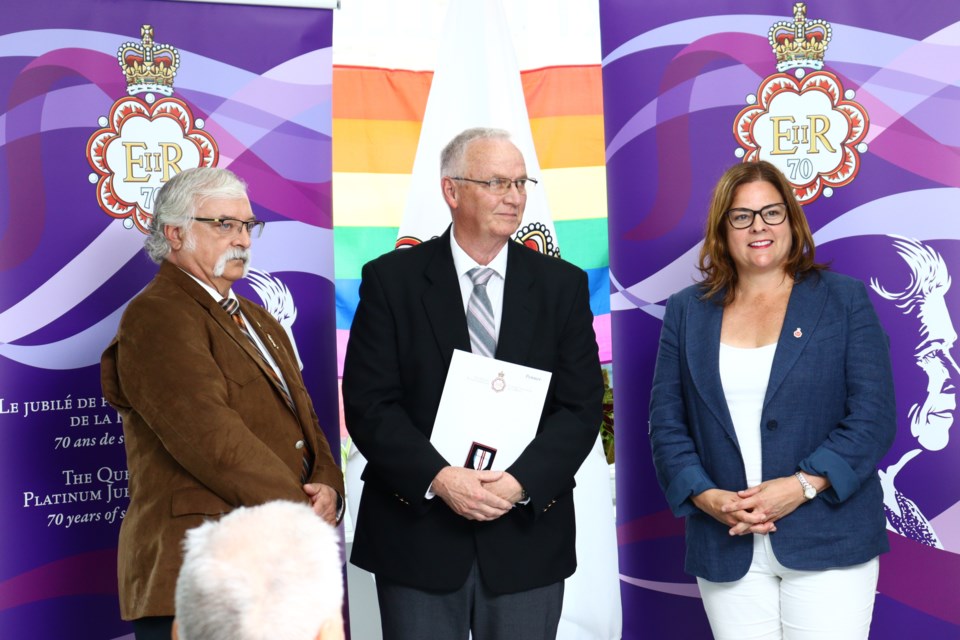 Bob Penner is presented with a Queen's Platinum Jubilee Award by MLA Tom Lindsey and Manitoba Premier Heather Stefanson.