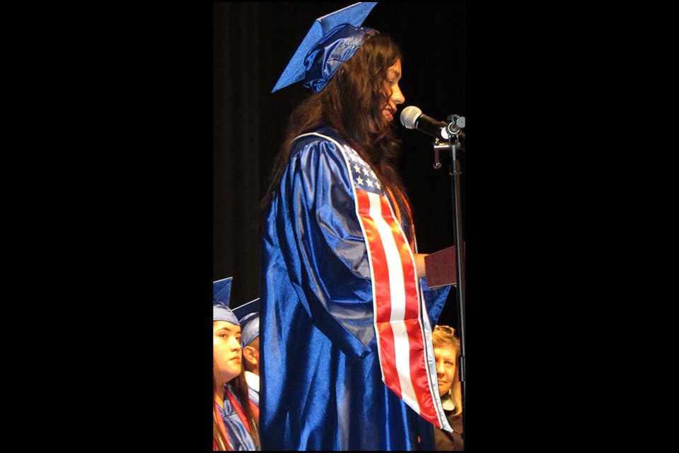 Heydi Flores speaks at the 2024 graduation ceremony for students attending Arlington Community High School.                   