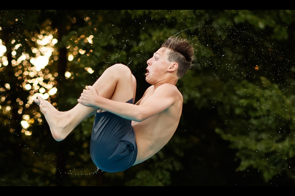 Quinn Coogen of Arlington Forest has a bit of a fearful look as he begins his tumbling dive.